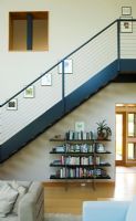Modern staircase in home above bookcase