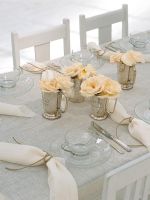 Dining table with flower vase and napkins