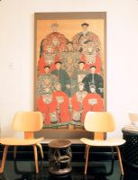 Two chairs with an Asian portrait painting