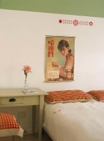 Bedroom with ethnic Asian poster and striped pillows
