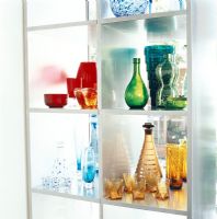 Colourful glassware on shelf