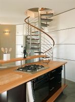 A contemporary wooden kitchen and spiral stairs