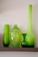 Green vases on shelf 