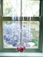 Roses in glass on window sill