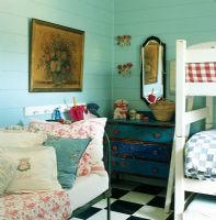 Bunk bed in bedroom with dresser and daybed