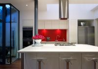 Modern kitchen with gas hob on island at night

