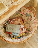 Overhead view of a wicker basket with books and magazines