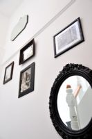 Pictures and mirrors on stairway wall