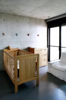 Cot in modern childrens room 