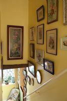 Country staircase with framed paintings 