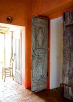 Rustic wooden doors in country corridor