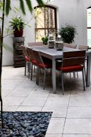 Modern dining table in courtyard garden 