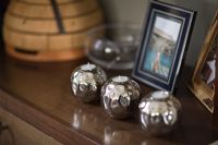 Silver candle holders on sideboard