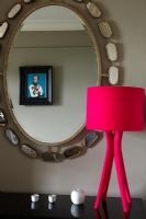 Sideboard mirror and red lamp