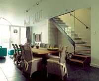 Modern dining room next to staircase 