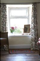 Floral curtains in country bedroom 