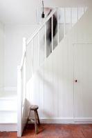 Country hallway with white staircase 