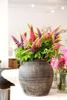 Colourful flowers in rustic vase 