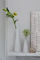 Vases and flowers on mantelpiece 
