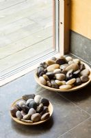 Bowls of pepples on stone tiled floor