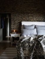 Modern country bedroom with dry stone wall