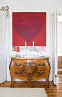 Console table and modern art in hallway