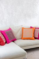 Cushions on sofa in modern living room, detail