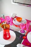 Elevated view of colourful glassware on dining table
