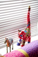 Colourful animal ornaments on windowsill