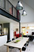 Open plan double height dining area with pendant lights