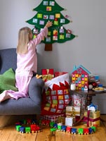 Girl opening Advent calendar at Christmas