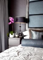 Contemporary bed with black bolster cushions