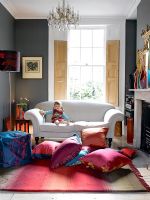Child sitting on sofa in colourful living room