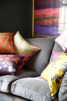 Colourful cushions on grey sofa