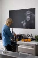 Woman using juicer in contemporary kitchen