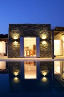 Luxury swimming pool and villa at night