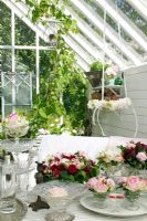 Conservatory with flower arrangements on table