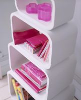 Pink accessories on modern shelf unit 