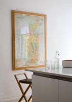 Modern kitchen with framed wall map