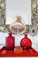 Red glassware and decorative mirror 