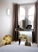 Modern bedroom with mirrored dressing table