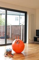 Space hopper and toys on wooden floor 