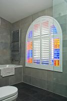 Modern bathroom with stained glass window 