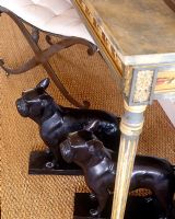 Pair of carved dogs under ornate console table