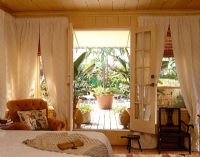 Country bedroom with french doors to terrace 