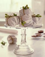 Decoratively wrapped cakes on cake stand