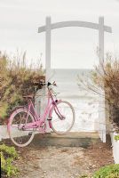 Pink bicycle by coastal gate 