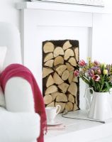 Stack of logs packed into classic fireplace 