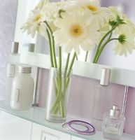 Vase of flowers on bathroom shelf 