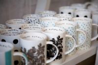 Collection of mugs on shop shelf 